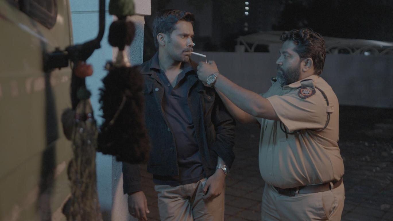 F.I.R. Diaries: a policeman lights a man's cigarette