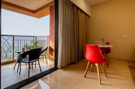Balcony room with red chairs