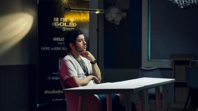Seated interview in front of event branding