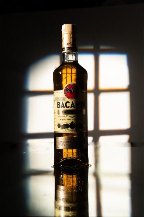Rum bottle in a window-shaped light